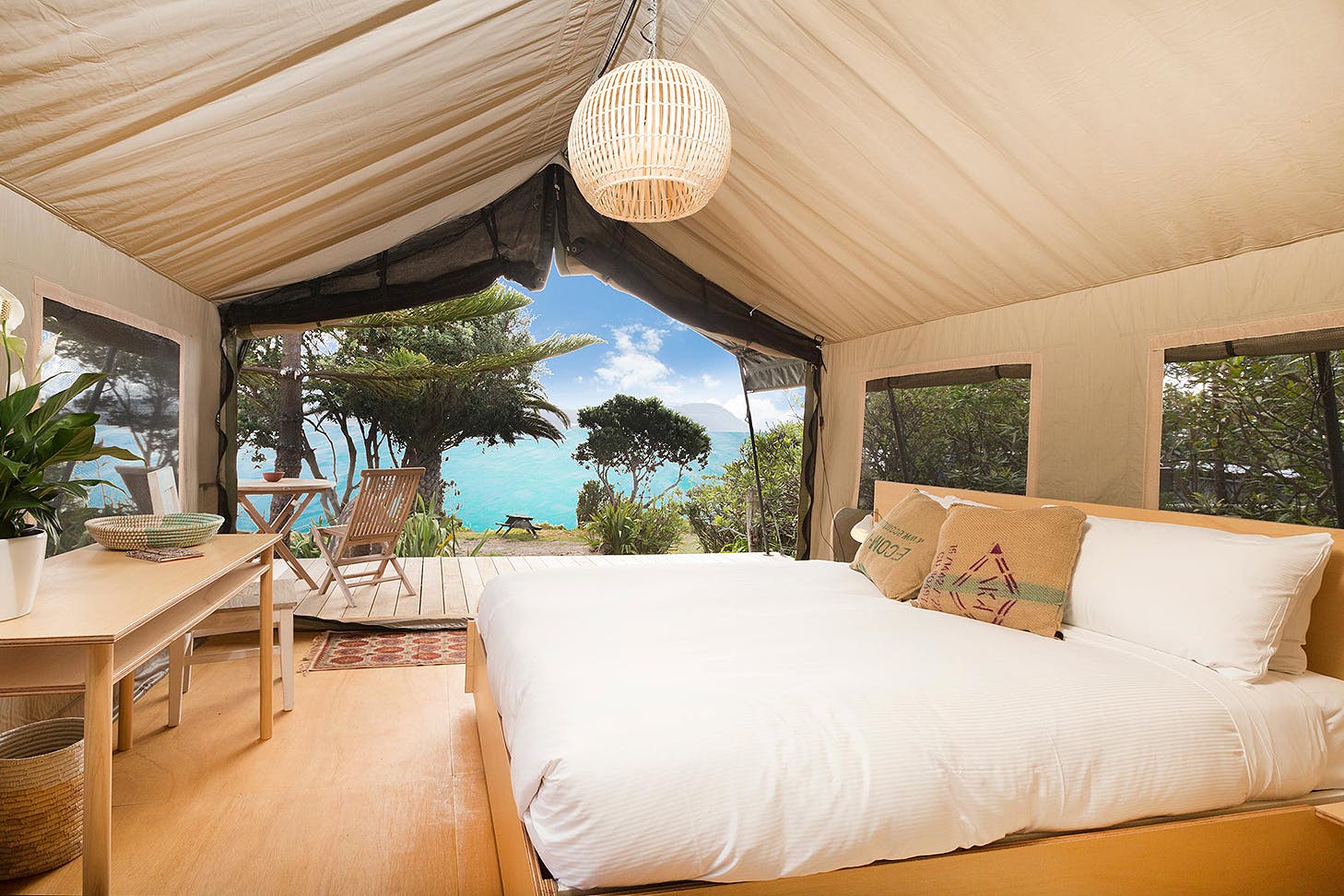 Glamping tent at slipper island looks out over impossibly blue sea.
